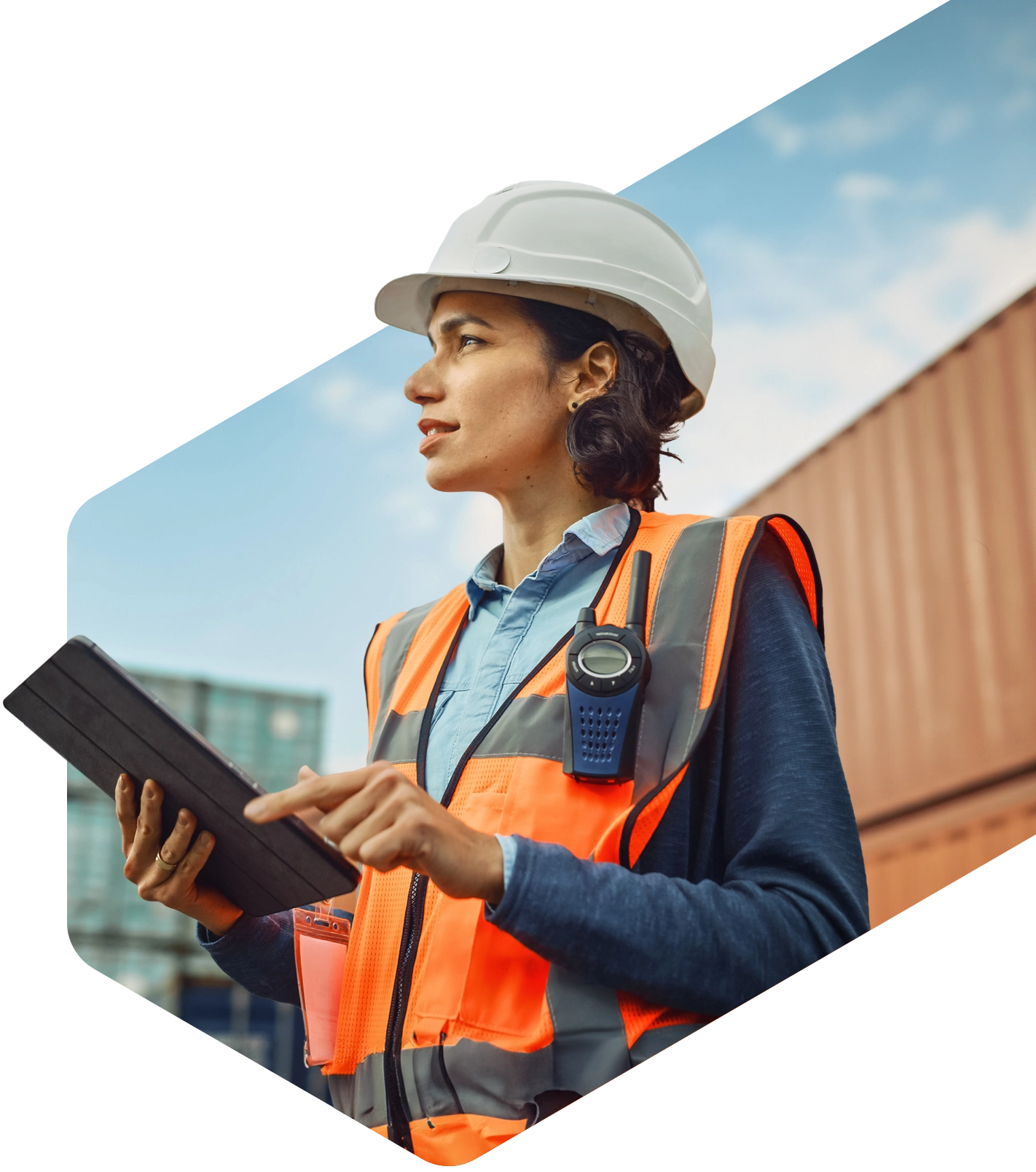 Worker in a hard hat and safety vest reviewing safety data sheets on a tablet